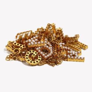 Detailed view of 18K gold plated alphabet charms with white pearls for DIY jewelry