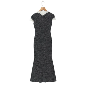 Women's black polka dot dress with white lace collar and mermaid hem on wooden hanger
