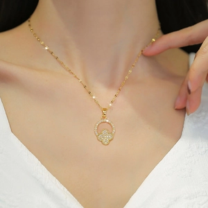 Elegant gold titanium clover necklace with zircons worn by a model for banquet style