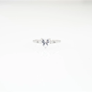 Minimalist heart-shaped moissanite ring with baguette side stones on white background