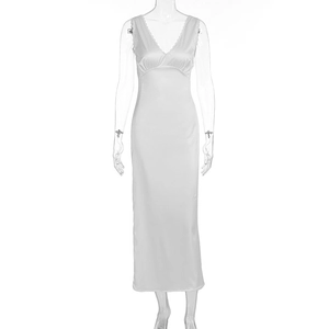 Detailed close-up of white satin dress featuring V-neckline with delicate lace trim