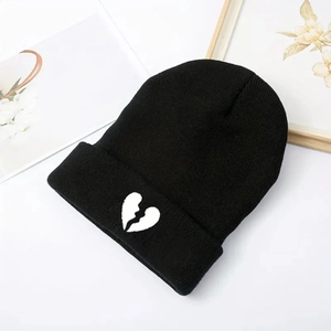 Unisex black knit beanie featuring a white broken heart embroidery and folded brim