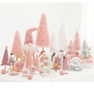 Détail de divers ornements de Noël roses et blancs sur un fond en peluche blanche douce