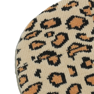 Macro view of the soft knitted texture and leopard print pattern on the warm beanie hat