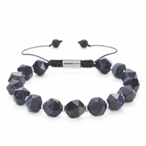 Macro detail of faceted blue goldstone beads and adjustable braided cord on a bracelet