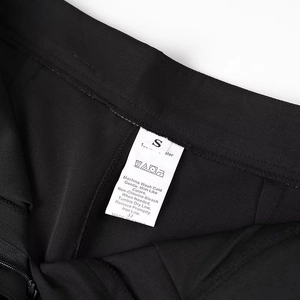 Detailed view of the garment care label showing 100% polyester material and washing icons