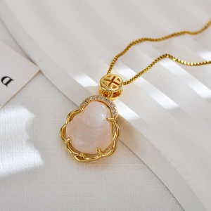 Macro view of gold-plated Maitreya Buddha pendant with pink opal and zircon accents