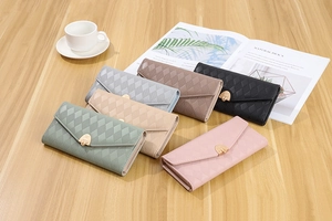 Detailed arrangement of long PU leather envelopes wallets with elegant heart gold clasps