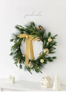 Close-up of a 50cm Nordic Christmas wreath with pine needles, gold bells and velvet bow