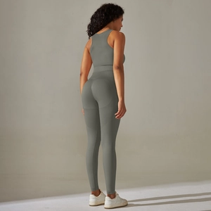 Rear view of seamless sage green yoga set showing cross back top and high waist leggings