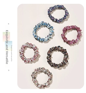 Detail showing set of six floral fabric scrunchies in various colorful patterns