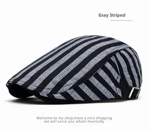 Detail view of cotton newsboy cap with grey stripes and adjustable metal side buckle