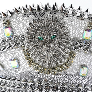 Silver sequin captain hat featuring metal spikes and a diamond-encrusted lion head emblem
