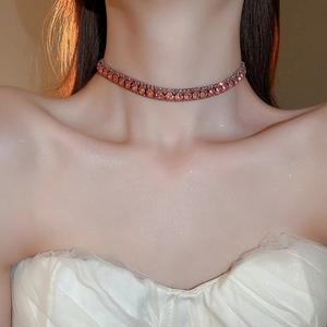 Close-up of elegant choker featuring square-cut orange-red gemstones on a female model