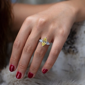 Close-up of luxury S925 silver ring with yellow marquise cut gem and side stones