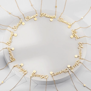 Set of 12 zodiac script letter necklaces in gold finish on a premium white display