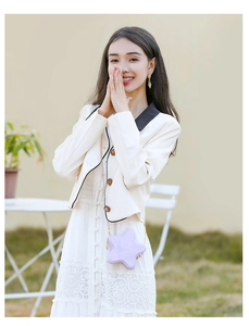 Close-up of a purple star-shaped PVC jelly bag paired with a white lace dress and jacket