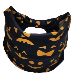 Detail of Halloween headband showing orange pumpkin face patterns on black elastic fabric