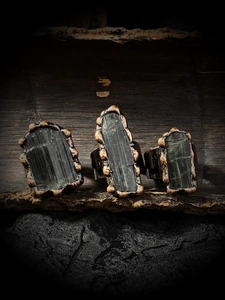 Macro detail of raw green tourmaline crystals with vintage bronze adjustable bands