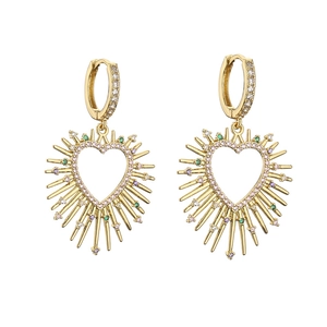 Detailed close-up of golden heart-shaped earrings with colorful pave zircon stones