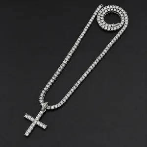 Silver tennis chain with large iced-out cross pendant in a 45-degree angled view
