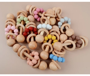 Multiple beech wood and silicone baby teething rattles in various vibrant colors