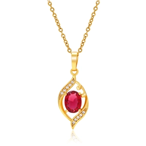 Detail shot of the golden necklace showing an oval red gemstone and tiny white crystals