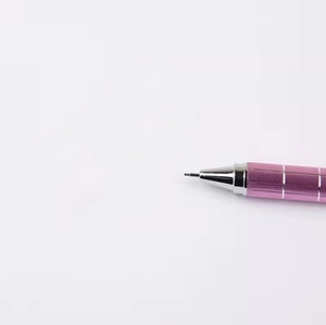 Pink grid patterned metal mechanical pencil writing on paper with silver tip detail
