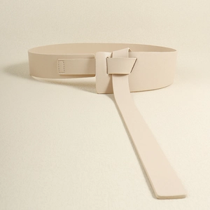 Detail of elegant beige wide knotted leather waist belt for dresses and coats