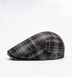 Side view of British plaid newsboy cap featuring adjustable metal buckle and woven texture