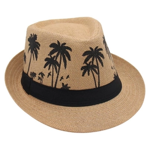 Detailed texture of woven straw fedora featuring black embroidered palm tree patterns