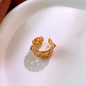 Gold plated wide band open ring featuring vertical brushed texture and zircon floral accents