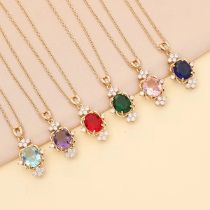 Showcase of six colorful semi-precious gemstone necklaces with crystal pavé on gold chain
