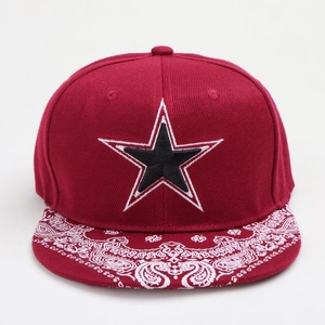 Macro shot of red snapback hat with paisley print brim and five-point star embroidery