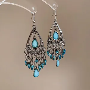 Bohemian vintage teardrop tassel earrings with blue stones and silver hollow patterns