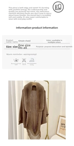 Close-up of brown knit poncho featuring luxury faux fur collar and decorative fringe trim