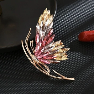 Elegant gold butterfly brooch with multi-colored crystals and diamond accents
