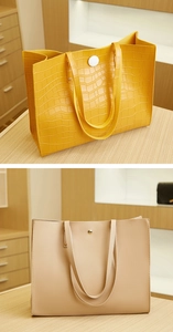 Detail view of yellow crocodile pattern leather and beige smooth texture tote bags