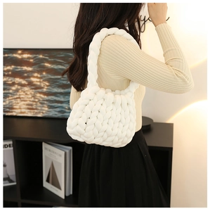 Detailed view of the thick white chunky knit bag texture and soft Icelandic yarn weave