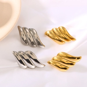 Fashionable angel wing textured earrings in gold and silver finish on white silk
