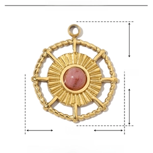 Macro detail of a vintage heart pendant in gold finish with pink natural stone