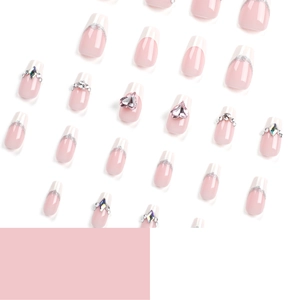 Pink gradient French press-on nails with sparkling heart gemstones and glitter accents