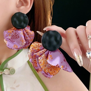 Black round stud earrings with purple silk floral fabric petals and vintage design