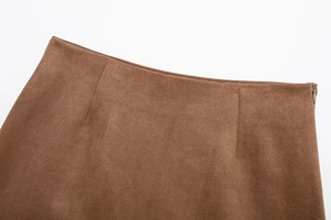 Detail of invisible zipper and stitching on the brown faux suede mini skirt waistline