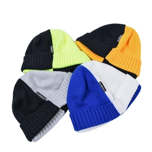 Detail view of multi-color ribbed knit beanies featuring premium fabric and side logo tags