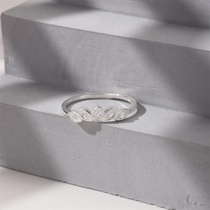 Close-up of S925 sterling silver ring with olive-shaped marquise zircons on concrete