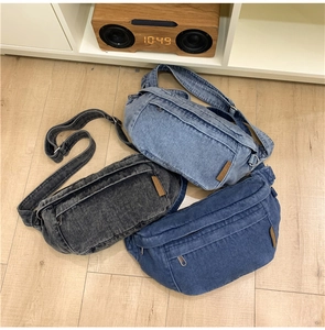 Flat lay of denim chest bags in light blue, dark blue, and grey with adjustable straps
