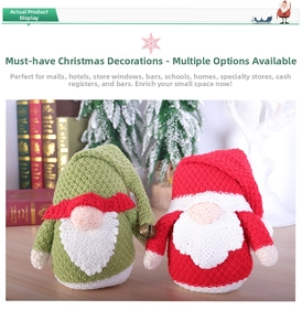 Detail of knitted Christmas gnomes with pointed hats and bells on a wooden table