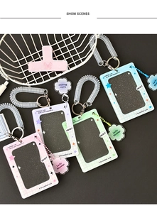 Close-up of four macaron-colored acrylic card holders with clover patterns and wristbands