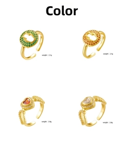 Detail view of 18K gold plated rings with Hamsa Hand and winged heart colored zircon